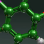3D molecular model of a benzene ring with green carbon, red oxygen, white hydrogen, and purple atoms